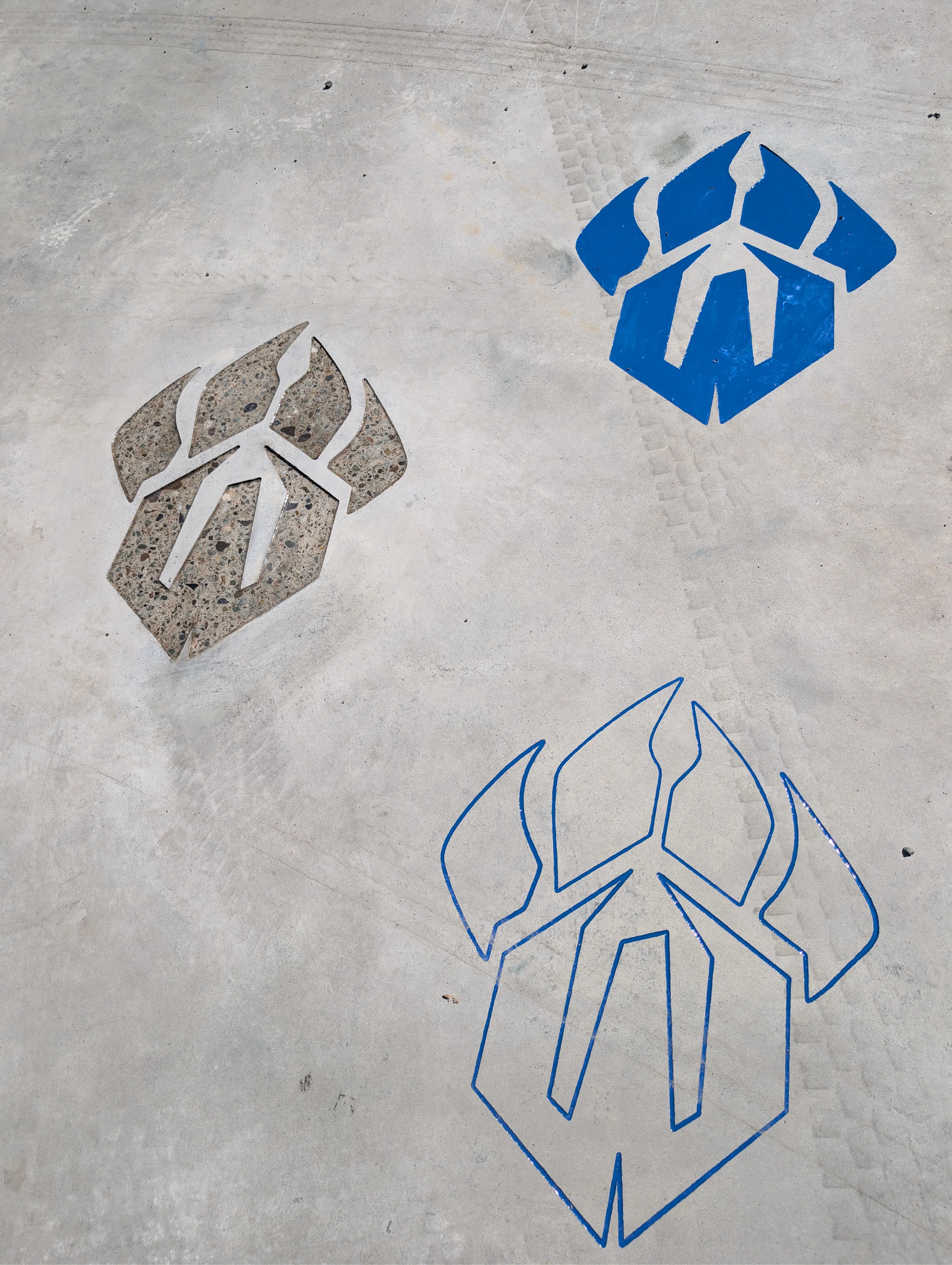Logo variations engraved into commercial concrete floor — BG Impressions